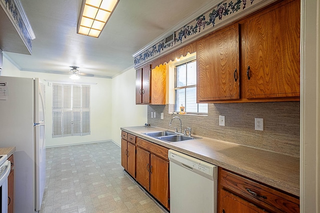 kitchen featuring ceiling fan, sink, backsplash, white appliances, and ornamental molding