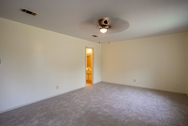 carpeted empty room featuring ceiling fan