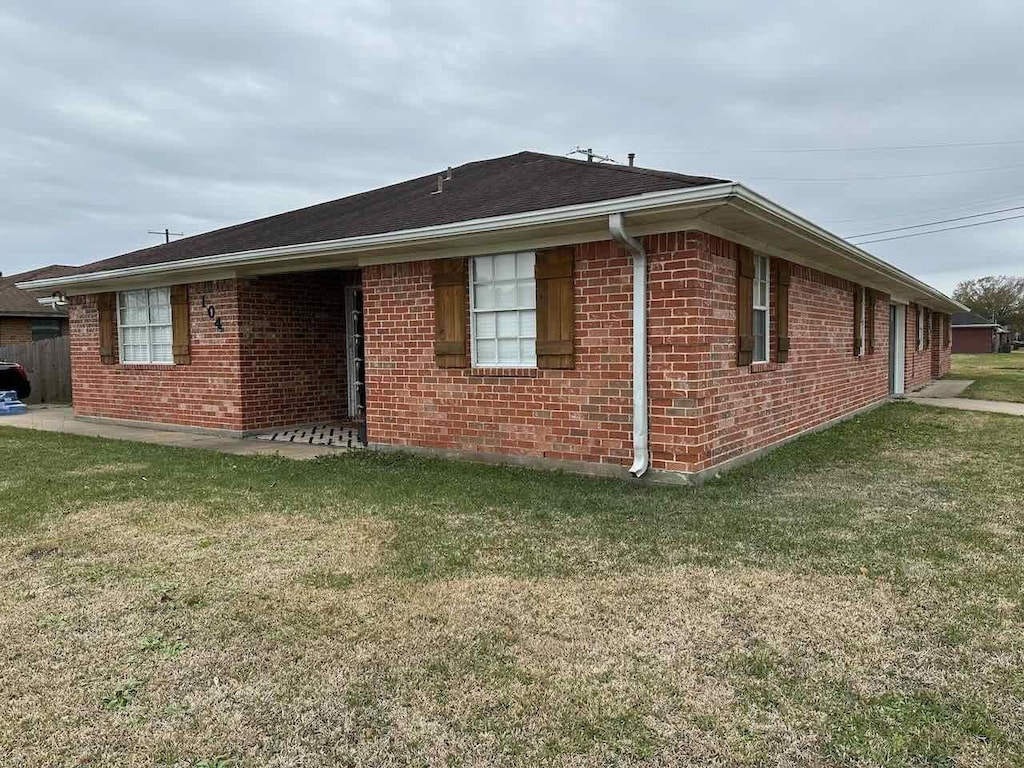 view of home's exterior with a lawn