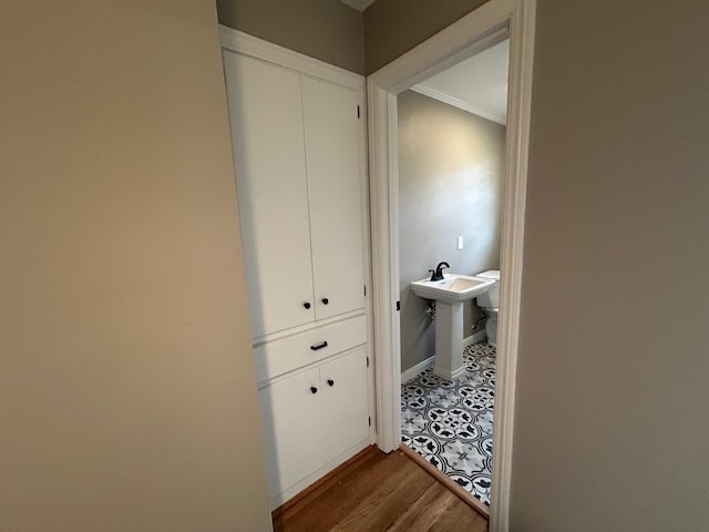 corridor featuring hardwood / wood-style floors and ornamental molding