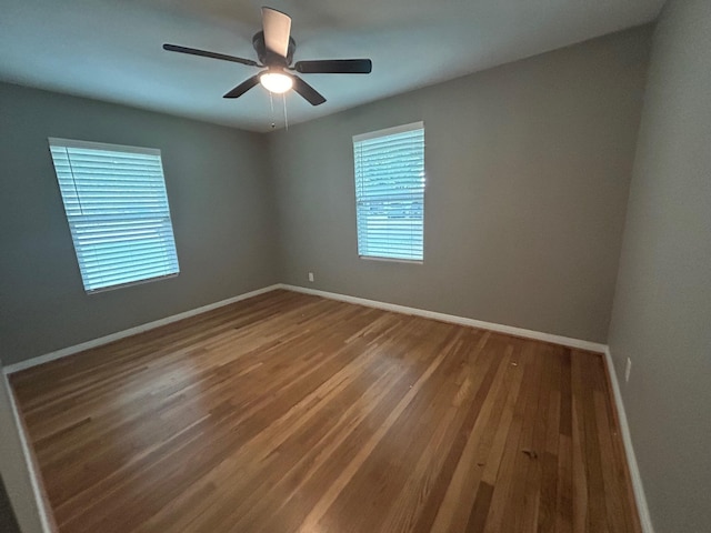 unfurnished room featuring ceiling fan and hardwood / wood-style flooring