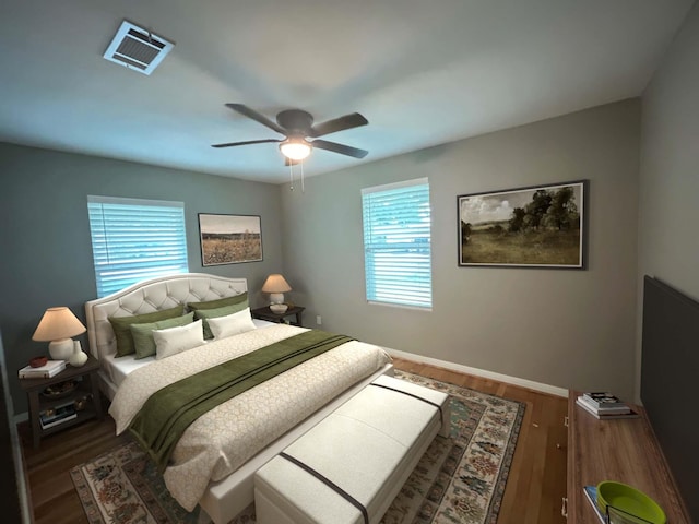 bedroom with dark hardwood / wood-style floors and ceiling fan