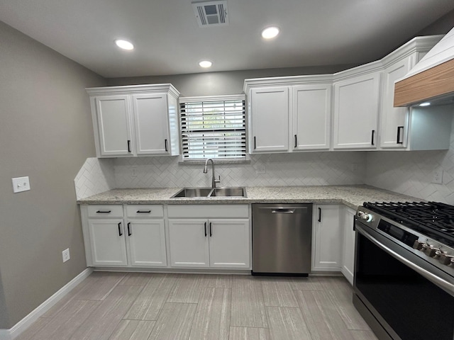 kitchen featuring sink, white cabinets, and appliances with stainless steel finishes