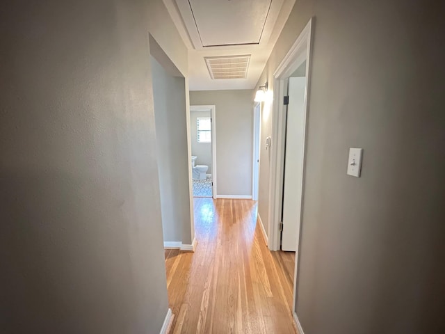 corridor with light hardwood / wood-style floors