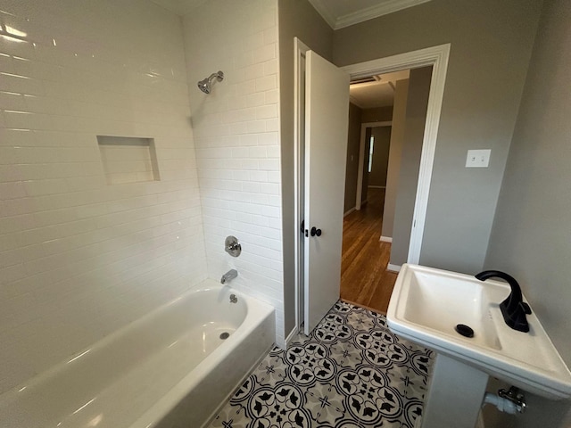 bathroom with tile patterned flooring, tiled shower / bath combo, and crown molding