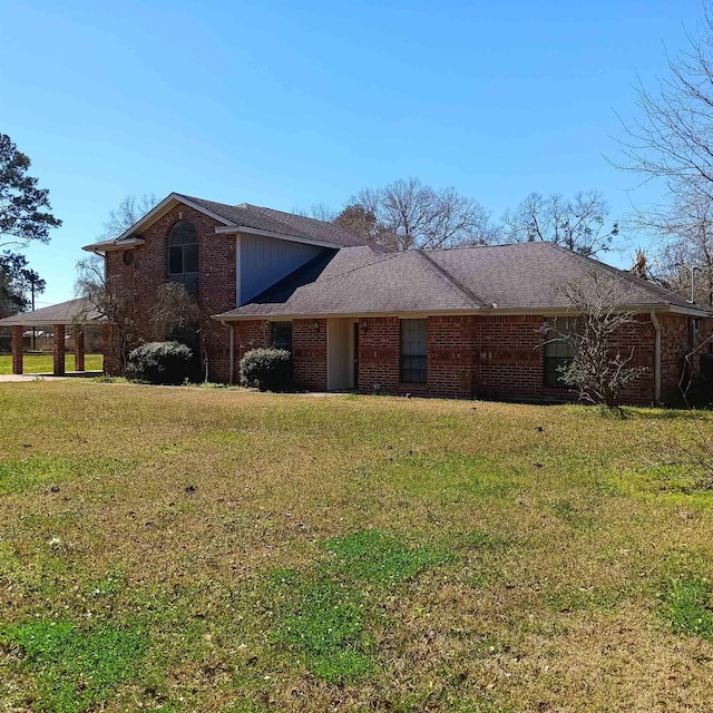 traditional-style house featuring brick siding and a front lawn