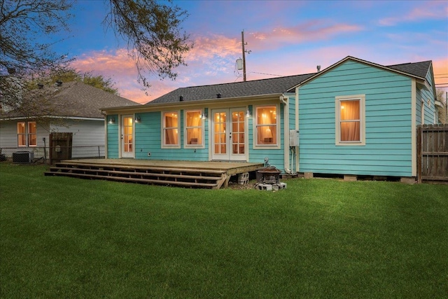 rear view of property with a deck, french doors, a shingled roof, and central AC unit
