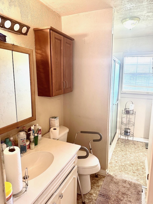 1895 Lucille St, Beaumont, TX 77705 - bathroom featuring a stall shower, vanity, a textured wall, and a textured ceiling