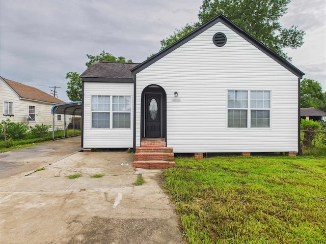 1832 19th St, Port Arthur, TX 77640 - view of front of home featuring entry steps, concrete driveway, a front lawn, and a detached carport