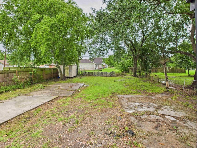 1832 19th St, Port Arthur, TX 77640 - fenced backyard featuring a storage unit