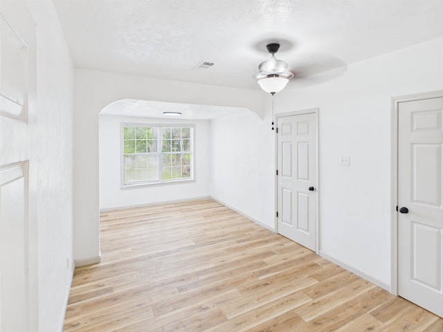 1832 19th St, Port Arthur, TX 77640 - unfurnished room with arched walkways, wood finished floors, and a ceiling fan