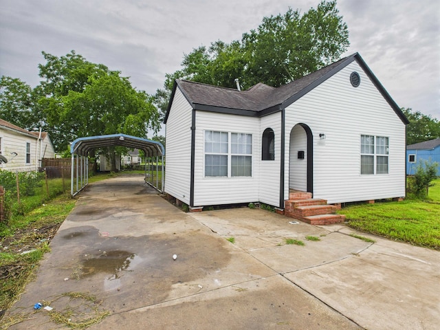 1832 19th St, Port Arthur, TX 77640 - view of front facade featuring a carport, concrete driveway, a shingled roof, and entry steps