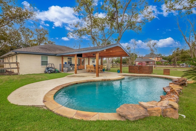 view of swimming pool with a lawn and a patio area