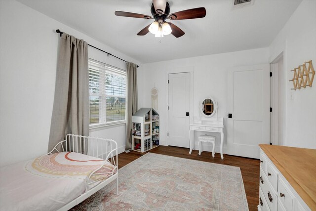 bedroom with ceiling fan and dark hardwood / wood-style floors