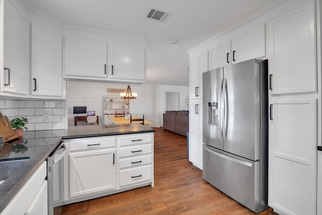 kitchen with white cabinetry, stainless steel appliances, and light hardwood / wood-style floors