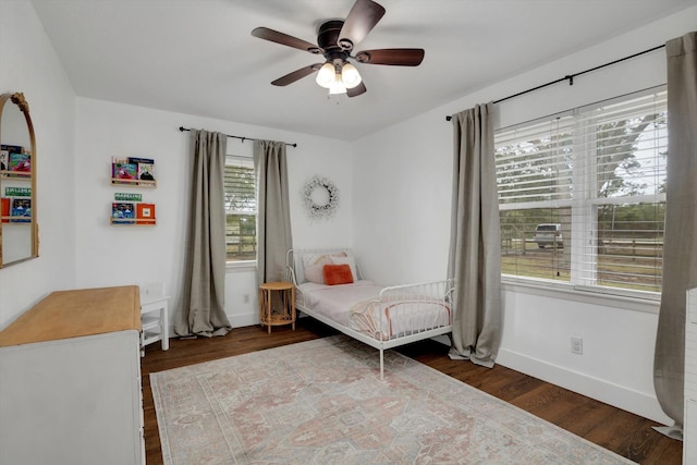 bedroom with dark wood-type flooring and ceiling fan