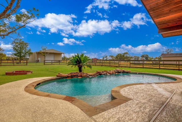 view of swimming pool featuring a yard and a patio area