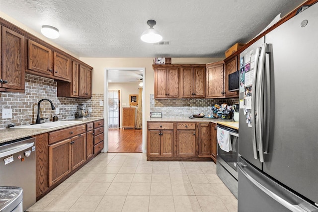 103 Read St, Silsbee, TX 77656 - kitchen featuring backsplash, visible vents, appliances with stainless steel finishes, a sink, and light countertops