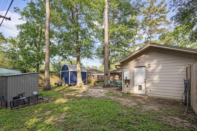 103 Read St, Silsbee, TX 77656 - view of yard featuring an outbuilding, a shed, and a fenced backyard