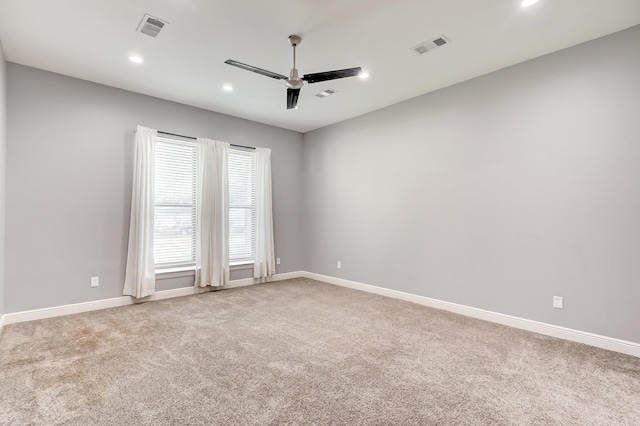 carpeted spare room featuring ceiling fan