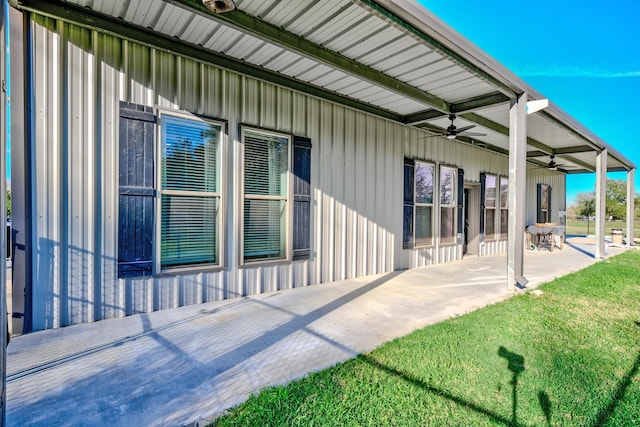 back of property with a lawn, ceiling fan, and a patio