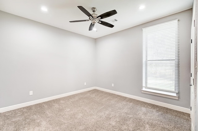 unfurnished room with ceiling fan and carpet floors