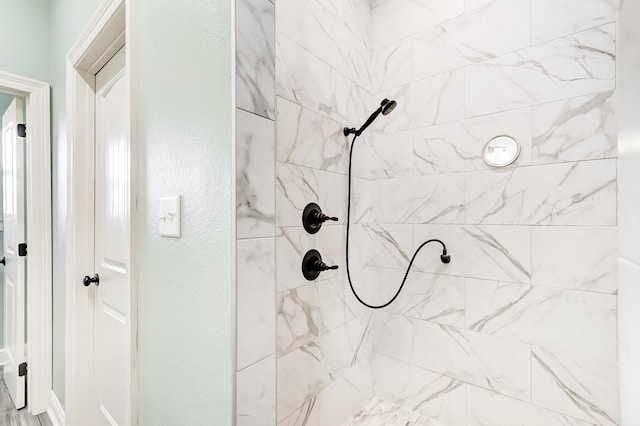 bathroom with a tile shower