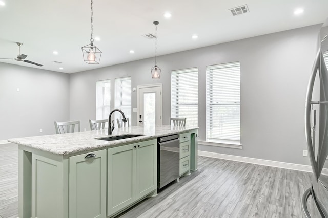 kitchen featuring pendant lighting, a kitchen island with sink, green cabinetry, ceiling fan, and stainless steel appliances