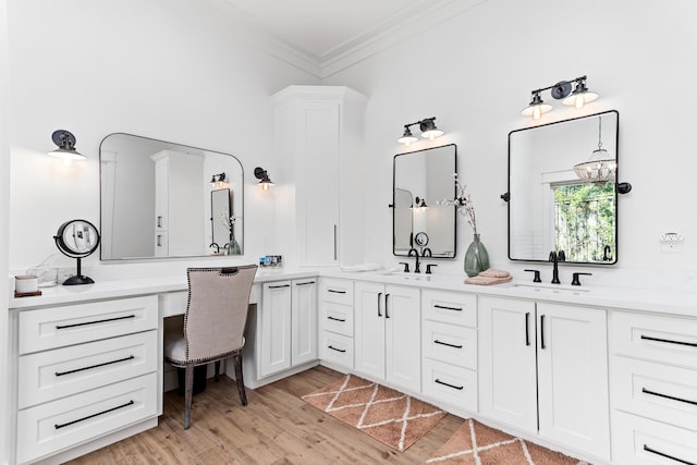 bathroom with hardwood / wood-style floors, vanity, and ornamental molding