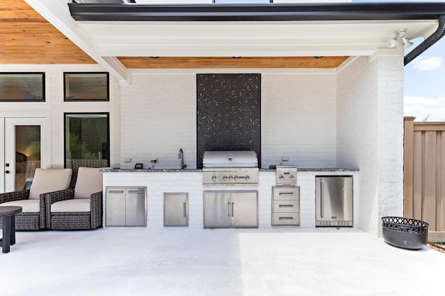 view of patio / terrace with sink, area for grilling, and a grill