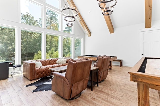 living room with beamed ceiling, light wood-type flooring, high vaulted ceiling, and an inviting chandelier