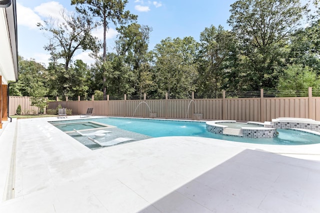 view of pool with a patio area, an in ground hot tub, and pool water feature