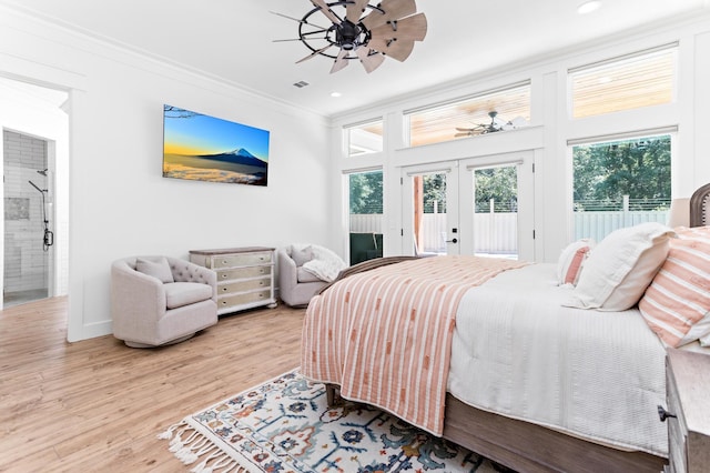 bedroom featuring french doors, ensuite bathroom, crown molding, access to exterior, and light wood-type flooring