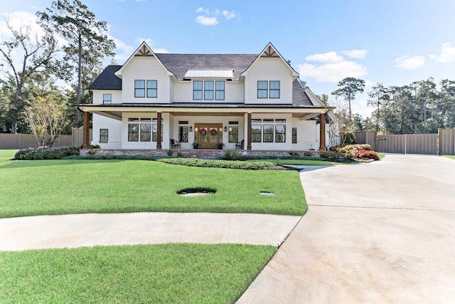 view of front of home with a porch and a front yard