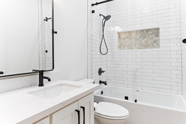 full bathroom with vanity, tiled shower / bath combo, and toilet