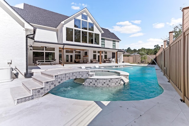 view of swimming pool with pool water feature, ceiling fan, an in ground hot tub, and a patio