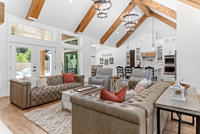 living room featuring high vaulted ceiling, french doors, light hardwood / wood-style flooring, beamed ceiling, and a notable chandelier