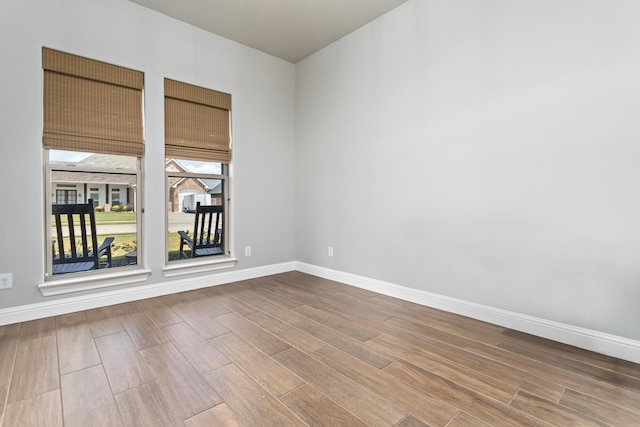 unfurnished room with wood-type flooring