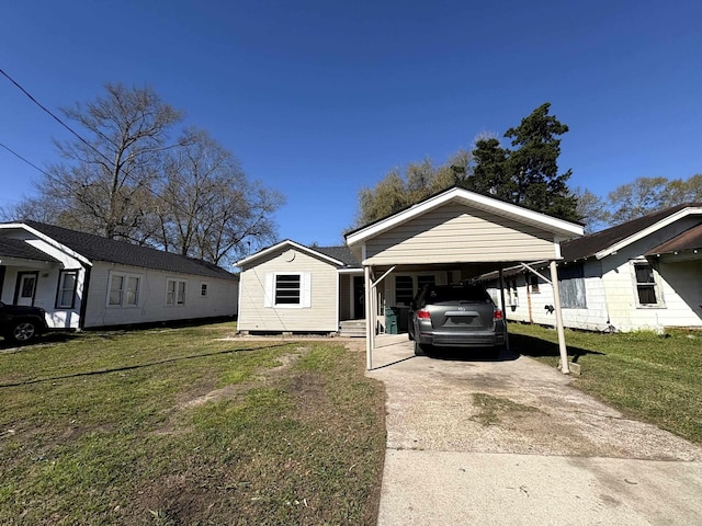 bungalow with a carport, concrete driveway, and a front lawn