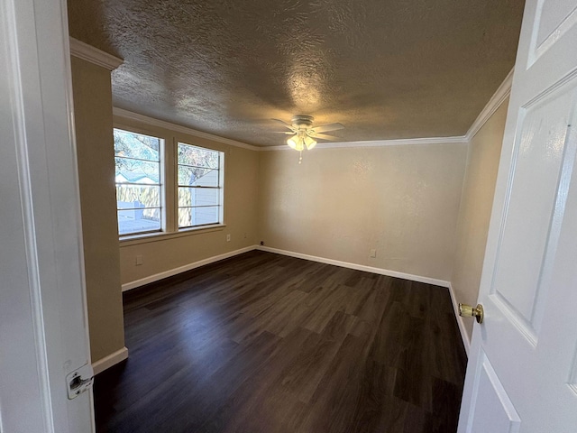 spare room featuring dark wood-style floors, baseboards, a textured ceiling, and ornamental molding