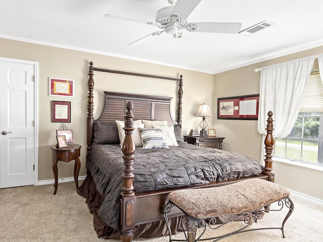 carpeted bedroom with ceiling fan and ornamental molding