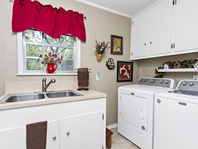 washroom with sink, cabinets, washing machine and dryer, crown molding, and light tile patterned floors