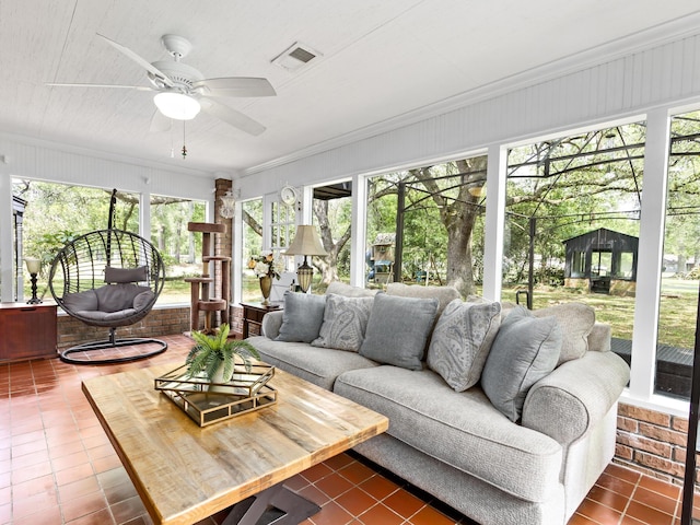 sunroom / solarium featuring ceiling fan