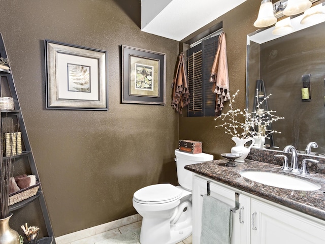 bathroom with tile patterned floors, vanity, and toilet