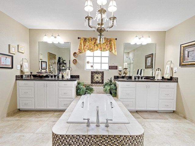 bathroom with tile patterned flooring, a relaxing tiled tub, and vanity