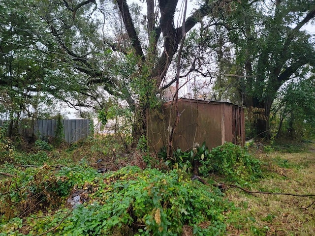 view of yard with an outbuilding and fence