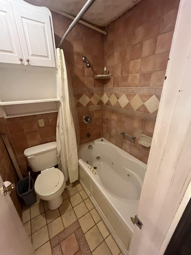 bathroom featuring shower / bath combo with shower curtain, tile patterned floors, toilet, and tile walls