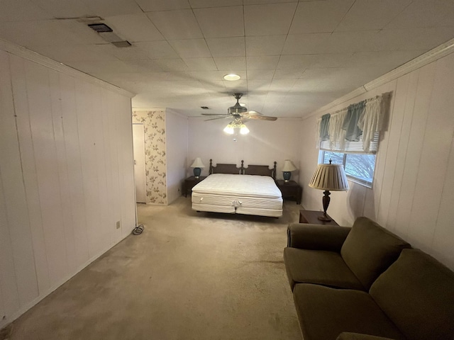 carpeted bedroom featuring ornamental molding and ceiling fan