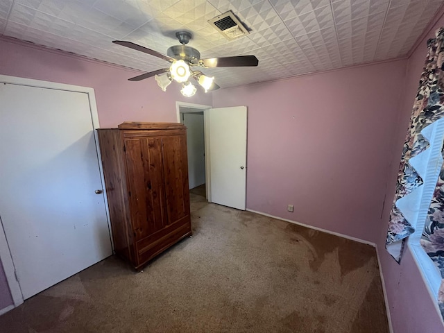 unfurnished bedroom with ceiling fan and carpet flooring