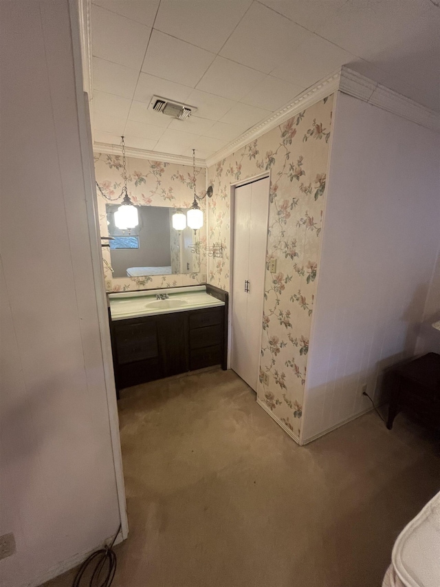 bathroom with ornamental molding and vanity